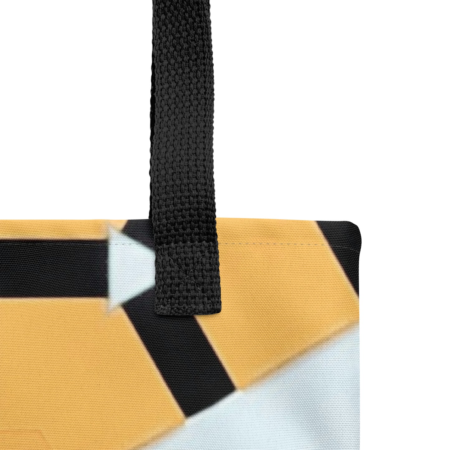 Unique geometric burst tan black white and blue print tote bag, close up of black handle durable material view